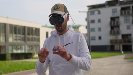 Front-view-of-adult-man-wearing-a-VR-or-augmented-reality-headset-outdoors