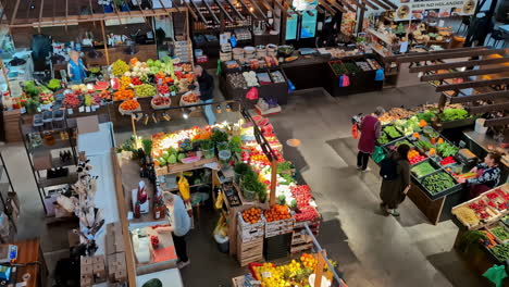 Buyers-At-The-Vegetable-Stalls-Inside-The-Agenskalns-Market-In-Riga,-Latvia