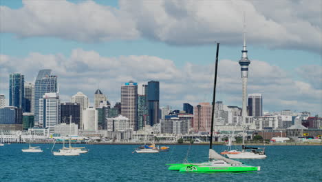 Multiple-boats-and-yachts-moored-up-in-Auckland-Harbour,-with-the-CBD-and-sky-tower-in-the-background,-New-Zealand