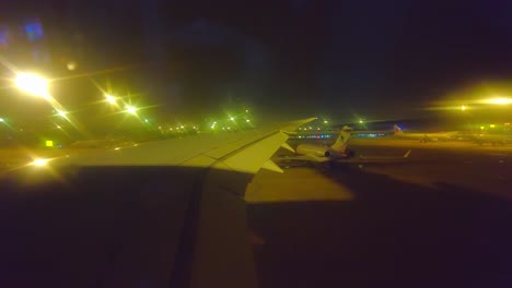 Night-time-view-from-airplane-window-while-taxiing-on-the-runway-at-Beijing-Capital-airport