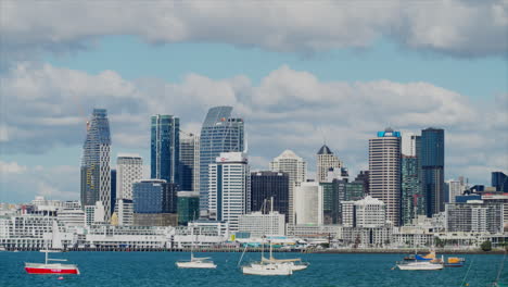 Multiple-boats-and-yachts-moored-up-in-Auckland-Harbour,-with-the-CBD-in-the-background,-New-Zealand