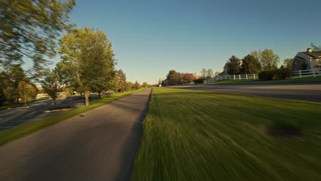 Speed-Flight-over-sidewalk-with-colorful-trees-and-street-in-American-neighborhood