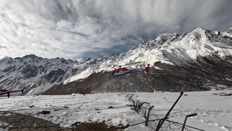 Witness-a-dramatic-helicopter-landing-amidst-snow-flying-around-in-the-High-Alpine-Kyanjin-Gompa-Valley-on-the-Lang-Tang-Trek-in-Nepal’s-Himalayas