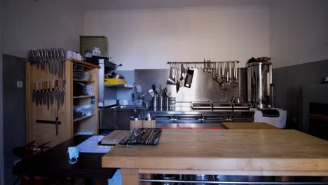 Kitchen-interior-view-with-wooden-table-and-kitchen-equipment
