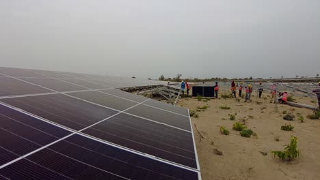 African-technicians-and-workers-installing-solar-panels-at-Jambur-Solar-PV-power-plant---static-wide-shot