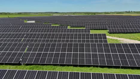 Vast-solar-panel-field-under-clear-blue-sky-with-green-grass