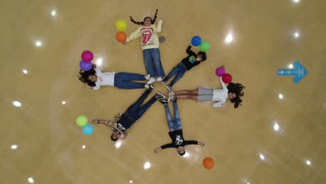 Aerial-top-down-showing-group-of-kids-waving-into-camera