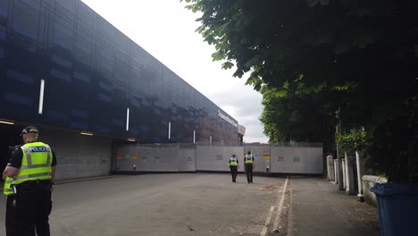 Two-police-officers-heading-towards-a-steel-barrier-at-Hampden-Park