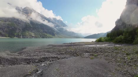 Aerial-flight-over-a-beautiful-big-Oeschinen-lake-on-a-mountain-in-Switzerland