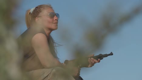 Female-military-soldier-with-a-submachine-gun-waiting-on-the-battlefield