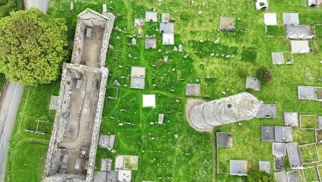 Ireland-Epic-locations-drone-looking-down-on-Ardmore-Round-Tower-and-cathedral,-monastic-site-of-saint-Declan-in-Waterford-on-a-bright-summer-day