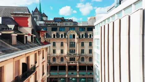 A-drone-slowly-flies-between-buildings-towards-the-facade-of-an-historical-building-in-downtown-Geneva,-Switzerland
