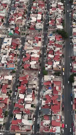 Vertical-drone-footage-captures-streets-of-Ecatepec,-Mexico,-offering-a-glimpse-into-urban-life-in-Latin-America