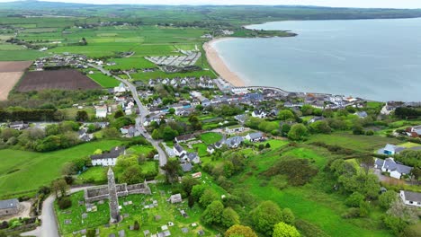 Ireland-Epic-locations-drone-flying-over-Ardmore-Round-Tower-and-village-to-the-beach-in-Waterford-on-a-bright-summer-day