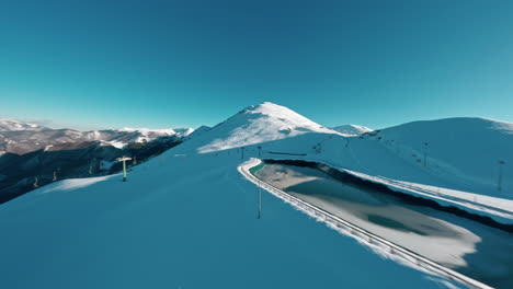 A-scenic-snowy-mountain-landscape-under-a-clear-blue-sky