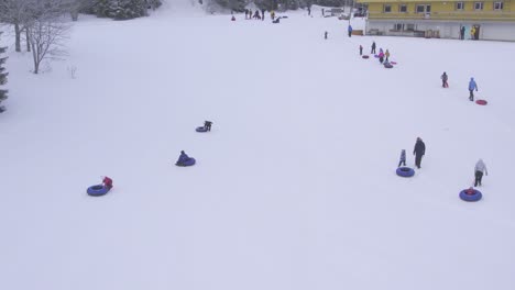 close-up-from-air-how-children-and-adults-walk-back-to-top-of-the-hill-so-they-could-slid-down-once-again