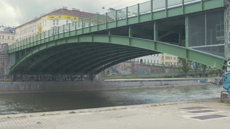 Green-steel-bridge-crosses-over-the-Danube-river