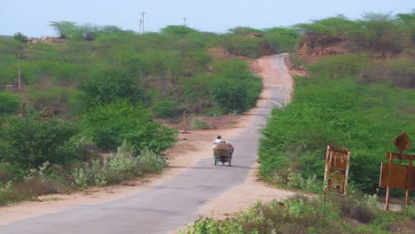 Aldeanos-Que-Viajan-En-Triciclo-A-Través-De-Una-Remota-Carretera-De-Aldea-En-Una-Región-árida-De-La-India