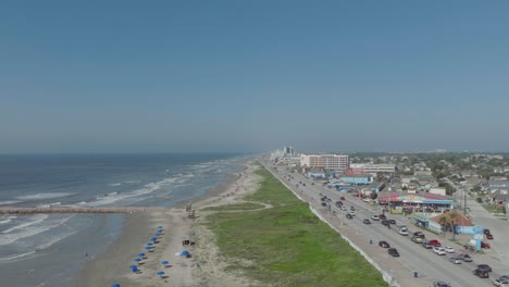 Eine-Luftaufnahme-Mit-Blick-Nach-Westen-Auf-Den-Seawall-Boulevard-Unter-Blauem-Himmel-In-Galveston,-Texas