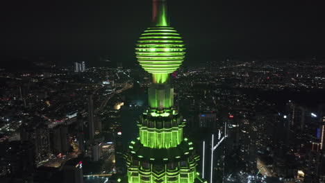 Drone-orbiting-the-illuminated-Observation-deck-on-the-Petronas-Twin-Towers,-in-KL