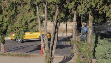 Yellow-car-driving-in-the-distance-on-Cappadocia-road