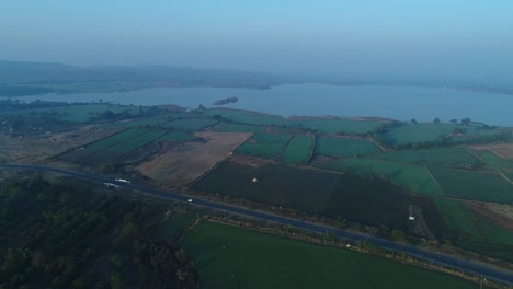 Large-fields-are-visible-in-the-drone-camera-and-a-large-lake-is-visible-in-the-background