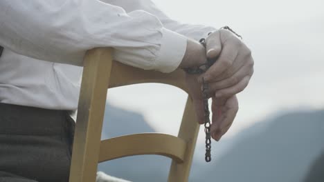 Man-standed-over-wooden-chair-wears-white-shirt-and-prepared-for-plan-execution-during-World-War-One