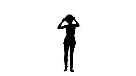Silhouette-of-a-dancing-woman-with-her-arms-raised