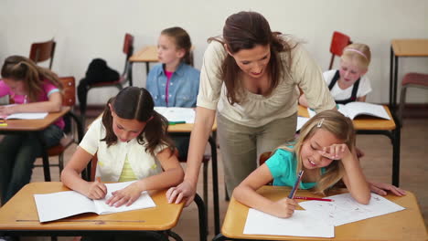 Cheerful-teacher-watching-her-pupils