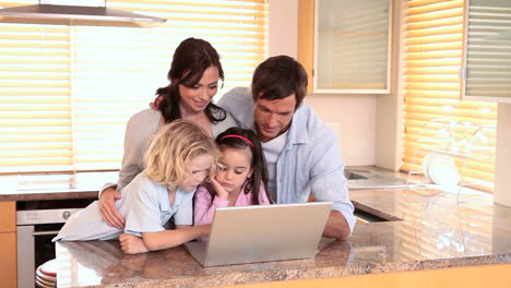 Family-looking-at-a-laptop-together