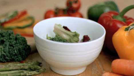 Vegetables-dropping-into-bowl-in-super-slow-motion