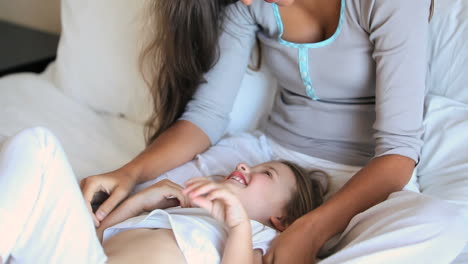 Mother-tickling-her-daughter-