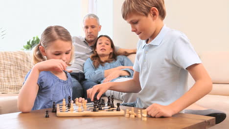 Smiling-siblings-playing-chess