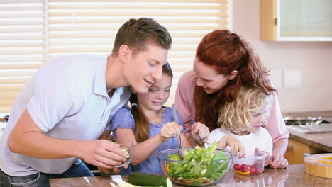 Family-making-a-salad-with-vegetables