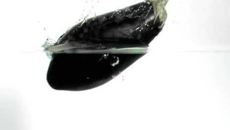 Aubergine-falling-into-water-in-super-slow-motion