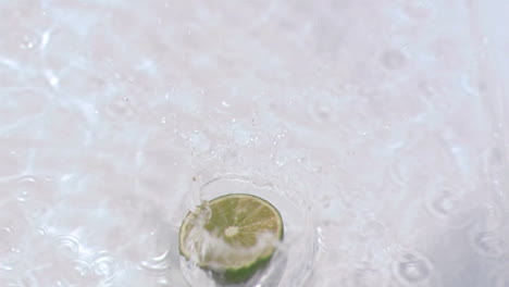 Lime-falling-into-water-in-super-slow-motion