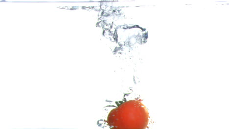 Tomato-submerged-into-water-in-super-slow-motion