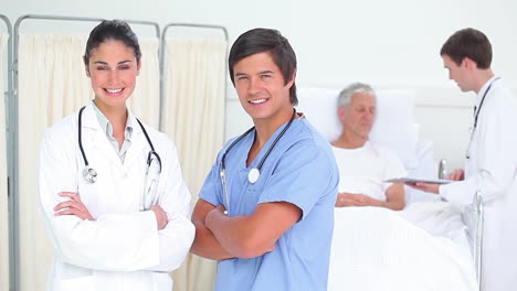 Smiling-doctors-standing-with-arms-crossed