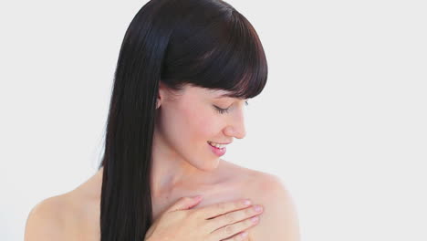 Smiling-brunette-woman-massaging-her-shoulder