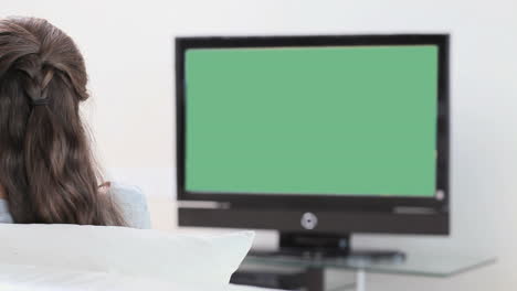 Rear-view-of-a-brunette-woman-watching-the-television