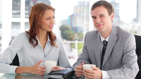 Smiling-colleagues-holding-cups-of-coffee