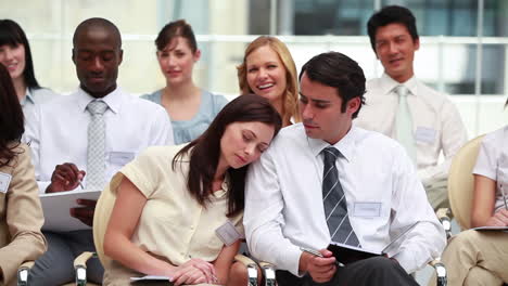Woman-sleeping-on-her-colleagues-shoulder-