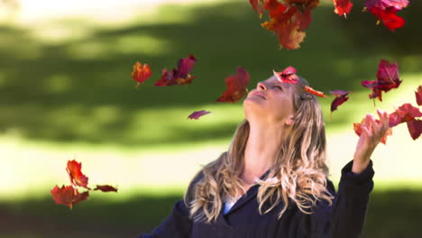 Blonde-woman-throwing-leaves-in-slow-motion