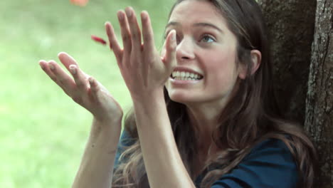 Smiling-brunette-in-slow-motion-throwing-rose-petals