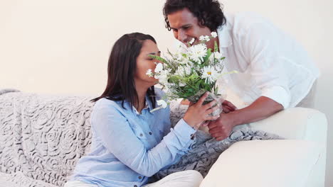 Woman-getting-surprised-with-a-bouquet-from-her-boyfriend