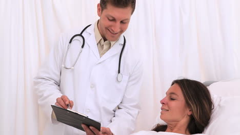 Doctor-showing-his-clipboard-to-his-patient