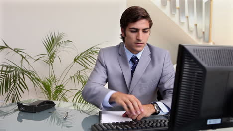 A-businessman-working-at-his-desk