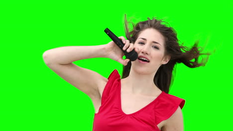 Woman-waving-her-arms-while-singing-into-a-microphone