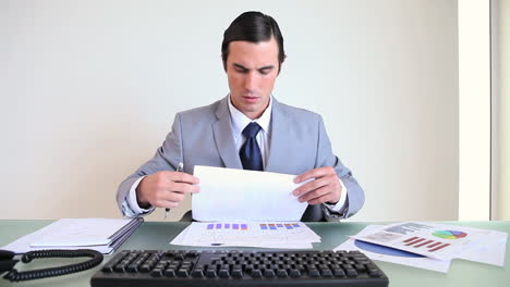 Serious-businessman-checking-documents