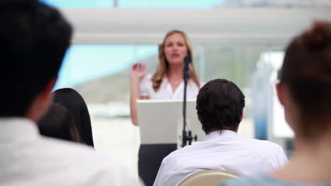 Blonde-woman-giving-a-conference